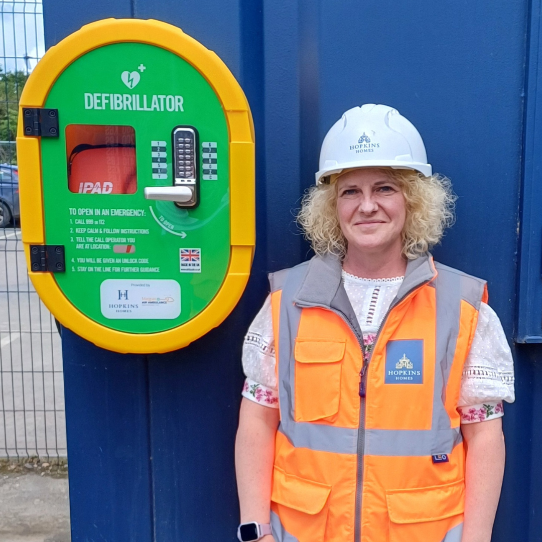 lady standing next to a defibrillator