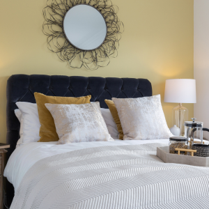 A small bedroom with a mirror at a Hopkins Homes new build development