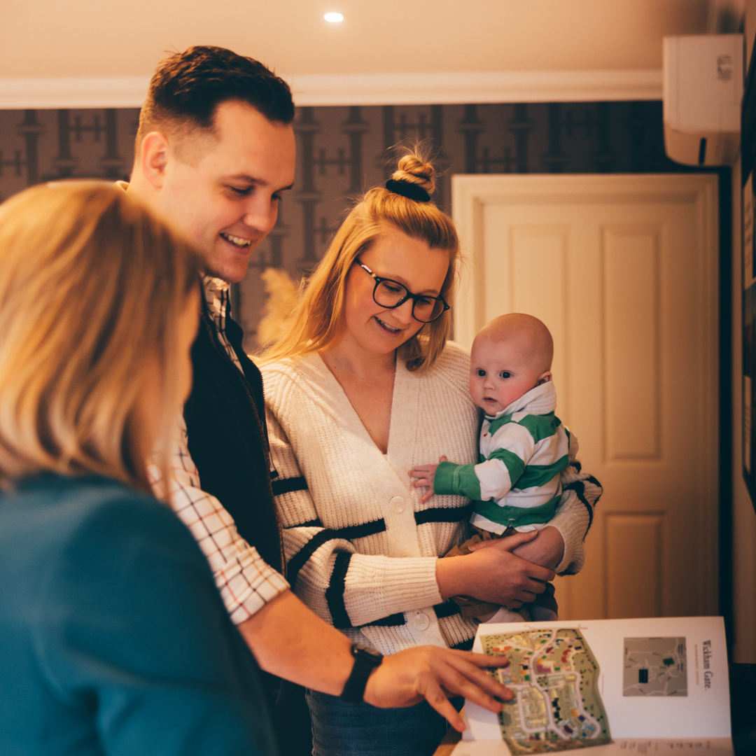 A young family in a Hopkins Homes sales office