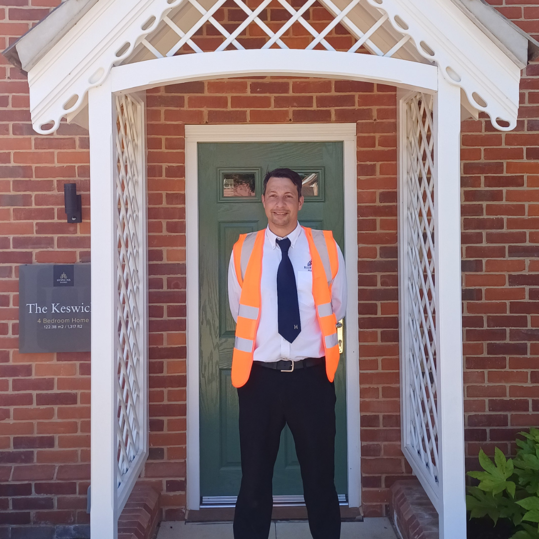 man standing in porch with hi-vis