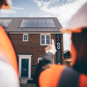 Woman pointing at house with PV panels