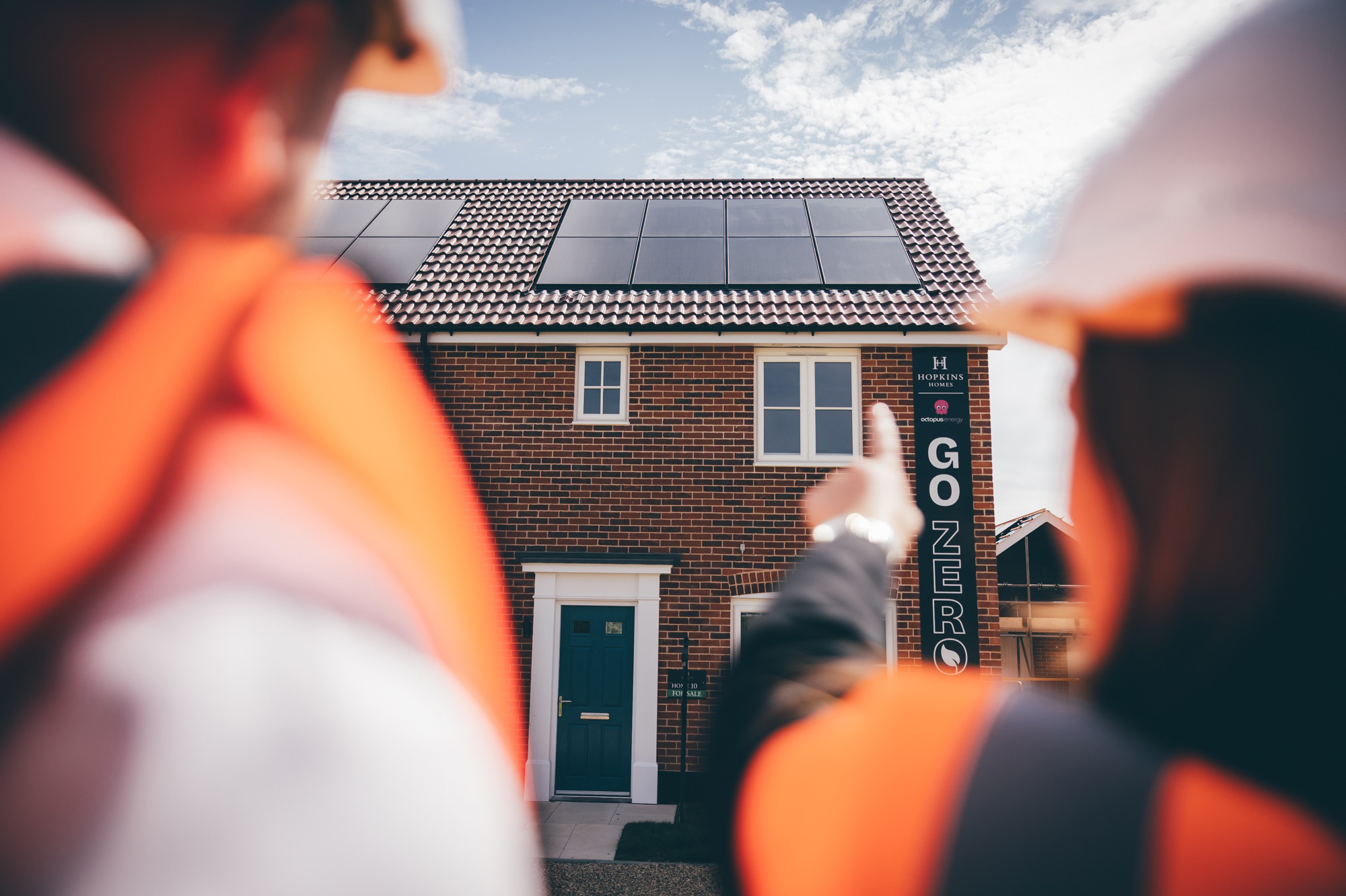 Woman pointing at house with PV panels